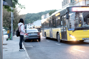 woman waiting for bus at bus stop