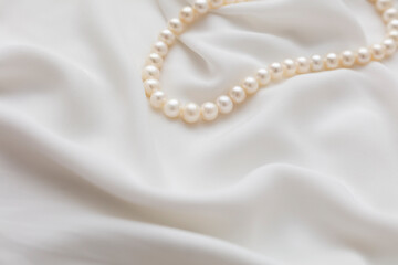 A pearl necklace against white background