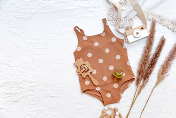 Vintage baby swimsuit on white background. Summer concept for kids, baby beach accessories. Top view, flat lay, copy space