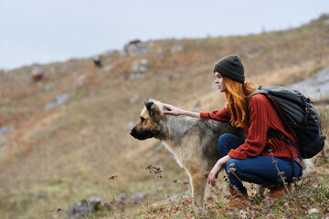 woman hiker with dog in mountains nature travel