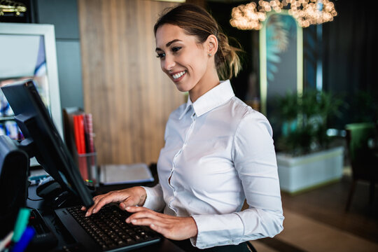 Young waitress working in cafe bar or restaurant.