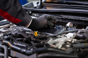 the car mechanic makes diagnostics of the car in the engine. car service and audit by an employee...