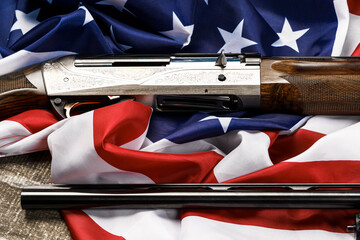 Automatic rifle on USA flag on wooden background