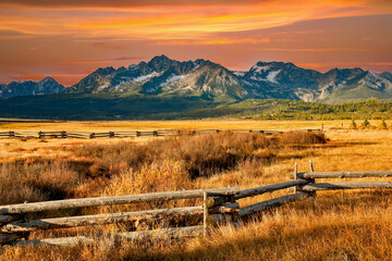a split rail fence, pasture and meadow, and the Sawtooth Mountains near Stanley, Idaho. - obrazy, fototapety, plakaty