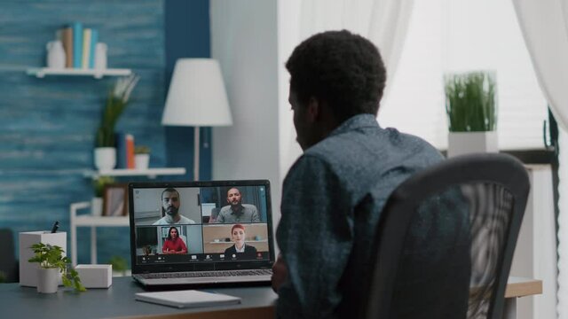 African american manager on online internet conference chat with his coworkers, remote working from home, using teleconference web communication with webcam. Black guy distance technology talking