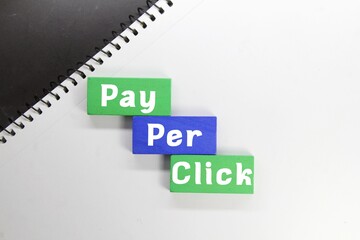 green and blue wooden cubes with words pay per click