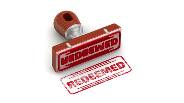 Redeemed. The stamp and an imprint. The stamp leaves a red imprint REDEEMED on a white surface. Footage video