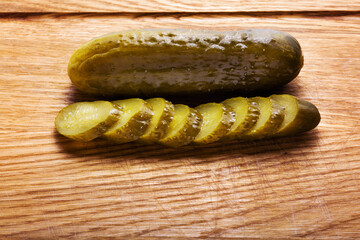 pickled cucumbers on a wooden board
