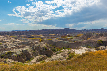 Fototapeta na wymiar Badlands landscape with sunbeam and dry grass in summer, Badlands national park, South Dakota, USA.