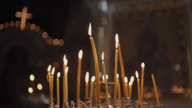 Candles burning in orthodox church. Vladimirsky Cathedral in Kiev. Candlestick with burning candles in the church. Christianity. Religion, faith. Religion and Orthodoxy in the Temples
