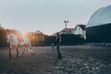 Beautiful young woman enjoying with her horse..