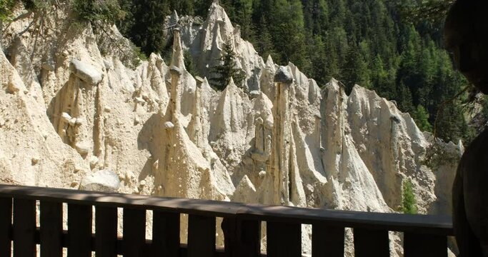 The incredible earth pyramids of Perca (Piramidi di Terra) in the Dolomites. Striking place in the Italian Alps. Sunny spring day. Pan right. Trentino Alto Adige. 4K UHD 59.94fps ProRes 422 HQ 10 bit