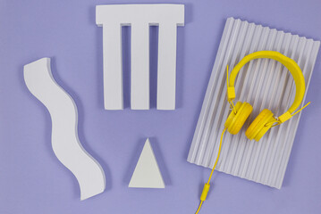 Geometric shapes for product presentation with headphones on violet background. Top view, flat lay. Music, still life