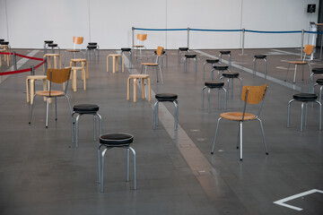 The chair and stool is arranged in new normal style for social distancing which one of the Coivid-19 countermeasure and prevention. This layout is for people gathering, meeting and quuening.