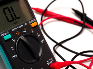 Picture of a digital multimeter, with red and black probe