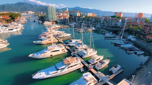view Marina and yacht club area in Puerto Vallarta near El Faro lighthouse with luxury hotels around.