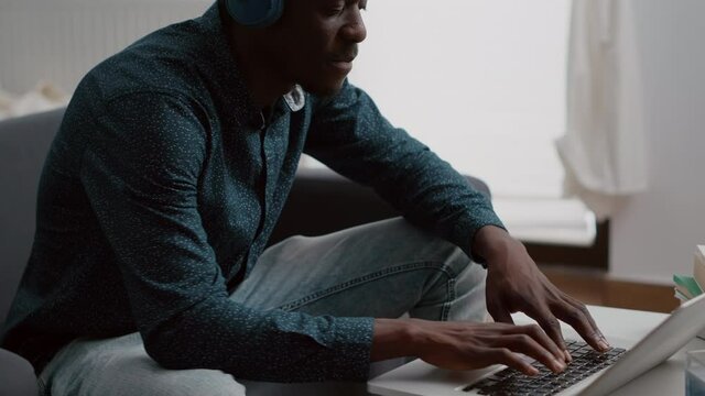 Close up black man hands browsing using laptop computer, searching social media. Authentic african american freelancer working with online internet connection