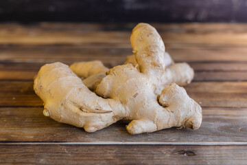 fresh ginger root on rustic wooden board blackground