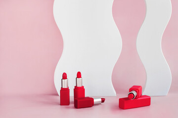 Mockup of red lipsticks on a white staircase with geometric shapes and a podium. Background for branding and packaging presentation. Beauty and makeup product concept