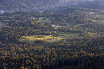 Naklejka premium Aerial View of the Farm Fields in Fraser Valley during sunny spring Sunset. Located in Chilliwack, East of Vancouver, British Columbia, Canada.