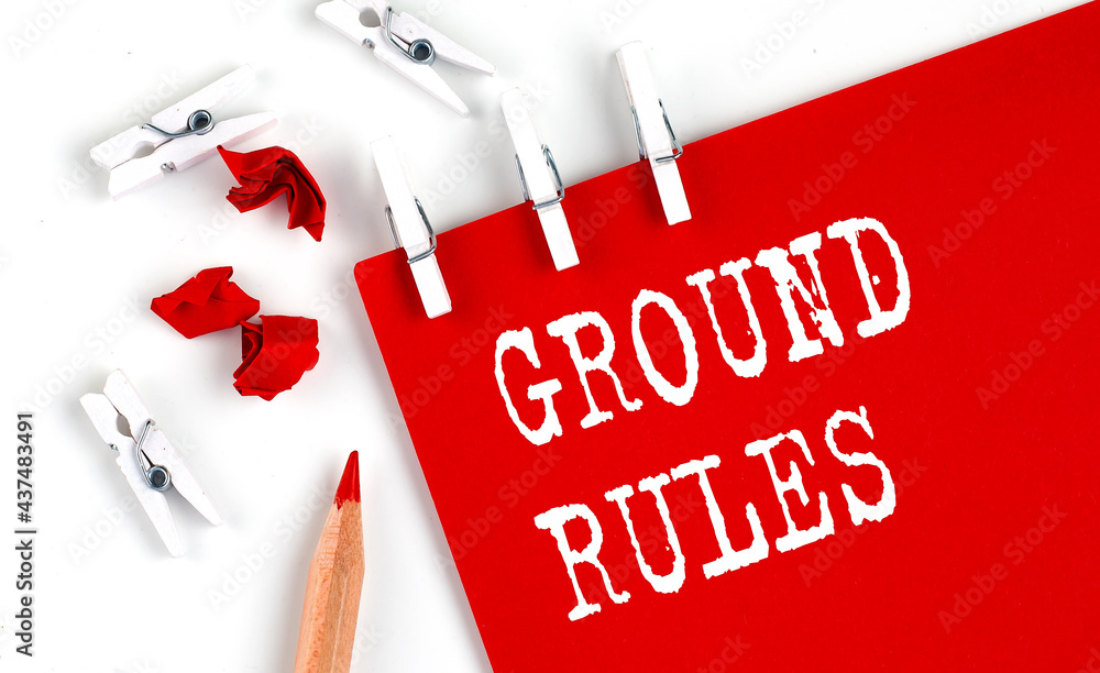 Poster ground rules text on red paper with office tools on the white background