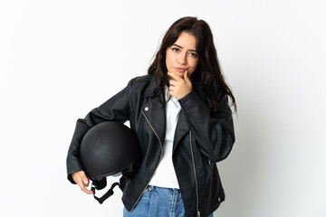 Woman holding a motorcycle helmet isolated on white background thinking