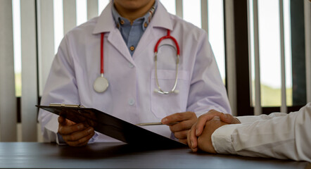 Doctors are writing prescriptions to patients who come to consult for advice from doctors.