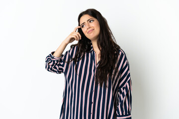 Young caucasian woman over isolated background making the gesture of madness putting finger on the...