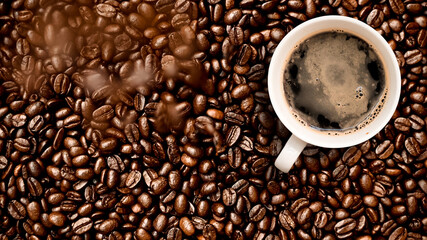 Cup of coffee with coffee beans on table