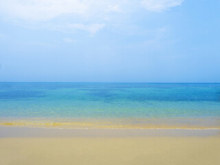 Fototapeta na wymiar Serene peaceful blue sea on tropical island beach under bright sun in summer. Koh Kood - Thailand