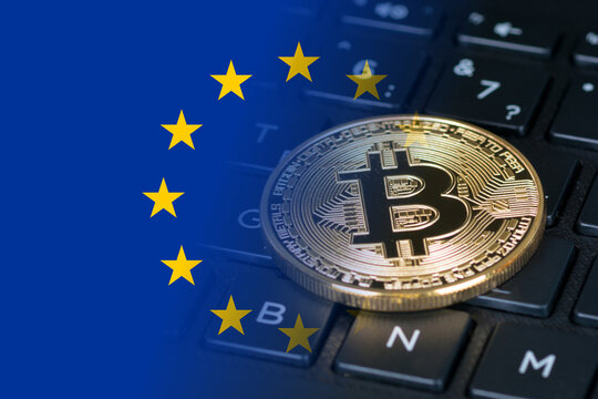 bitcoin golden coin on black keyboard and eu flag, mixed image