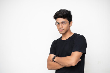 Young Independent boy standing on a white wall, arms folded, startup and business