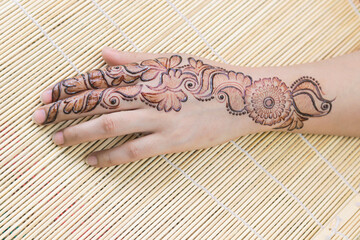 Woman Hands with black mehndi tattoo. Hands of Indian bride girl with black henna tattoos. Hand...