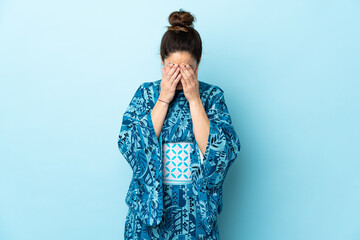 Woman wearing kimono over isolated background with tired and sick expression