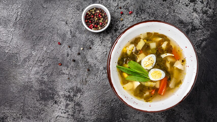 Traditional Latvian soup with sorrel and eggs, potatoes on a white background. called green borsch, banner, menu recipe place for text, top view