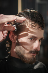 brunet man getting haircut