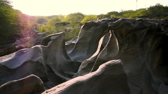 View of  sunset light over large naturally carved rocks at river canyon. Khari river, Kutch, India
