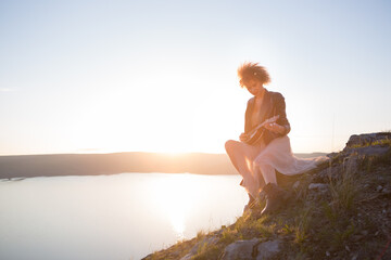 Fototapeta na wymiar Woman with guitar ukulele in the mountains, amazing landscape, stunningly beautiful nature, mountains, sunset Hiking in the mountains