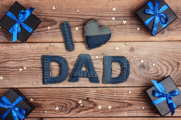 Father's day message from denim letters on an old wooden background.