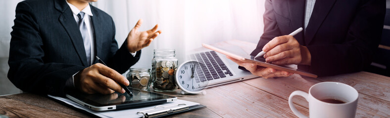 businessman holding coins putting in glass and using calculator. concept saving money and finance accounting.