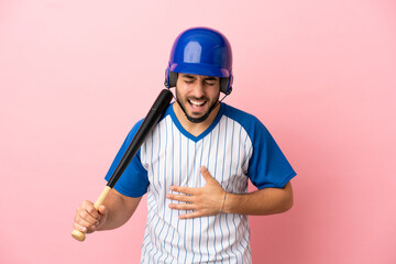 Baseball player with helmet and bat isolated on pink background smiling a lot