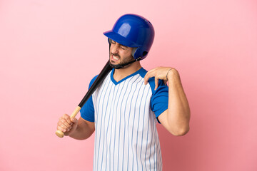 Baseball player with helmet and bat isolated on pink background suffering from pain in shoulder for having made an effort