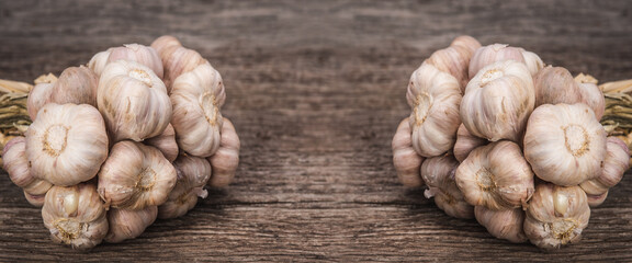 Fototapeta premium Garlic.Garlic in wooden on a rustic old table.