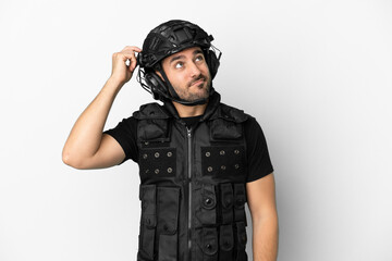 Young caucasian swat isolated on white background having doubts and with confuse face expression