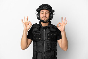 Young caucasian swat isolated on white background in zen pose
