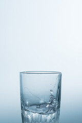 Splash, splashing water in a glass on a white background