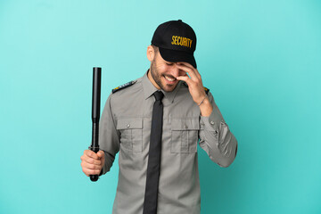 Young security man isolated on blue background laughing