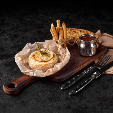 Baked Camembert cheese with nuts and honey.