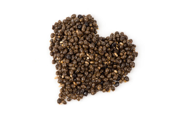 Arranged papaya seeds heart shape isolated on white background.