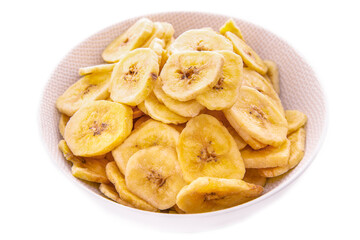Banana chips in a white plate on a white background, isolated products